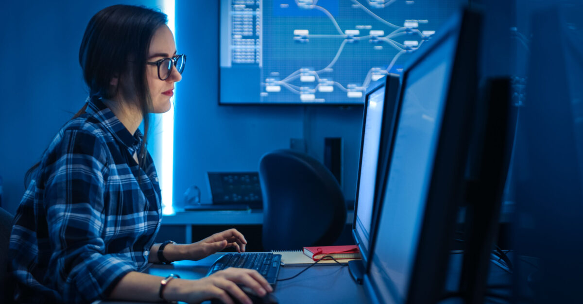 Smart Female IT Engineer / Programer Working on Desktop Comuter. Software Development / Coding/ Web Design / Database Architecture. Young Girl STEM Graduate Working Smart Female IT Engineer / Programer Working on Desktop Comuter. Software Development / Coding/ Web Design / Database Architecture. Young Girl STEM Graduate Working